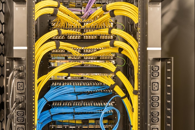 Photo tidy patched network cables rj45 connected to the switches and routers data centre