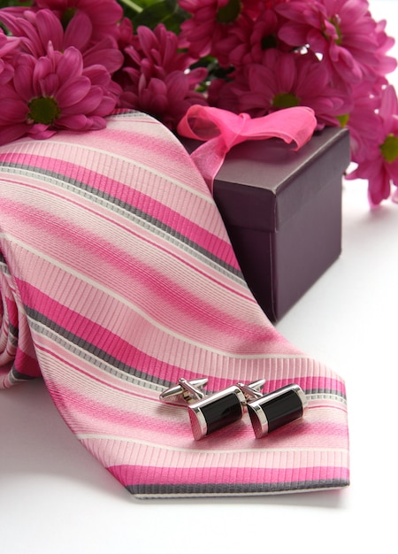 Tie and cuff links with flowers over white