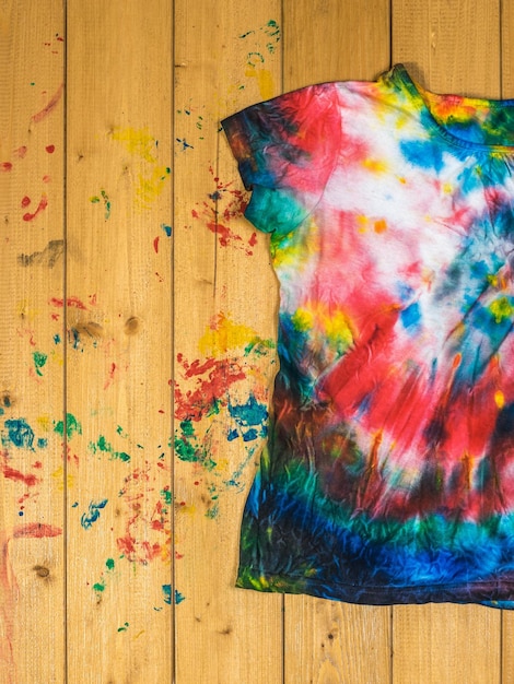 tie dyestyle tshirt on wooden boards flat lay