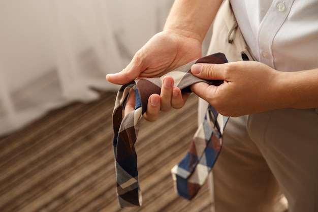 Tie in groom's hands