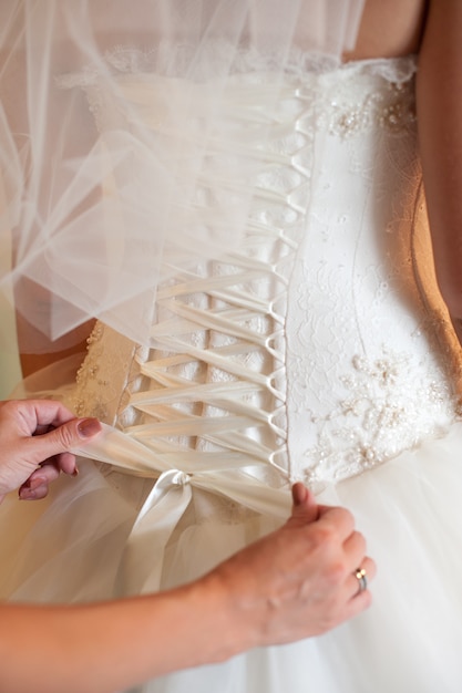 Photo tied bow knot on a wedding dress corset