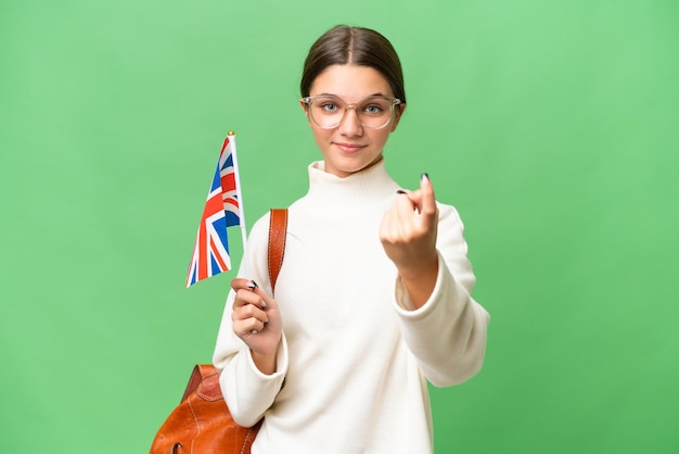 Tiener student blank meisje met een vlag van het Verenigd Koninkrijk over geïsoleerde achtergrond doen komend gebaar