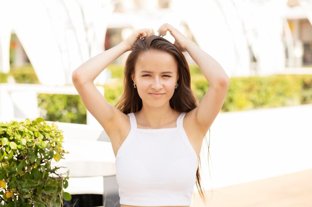 Tienermeisje in de zomer in een café aan de kust glimlacht poses zomer- en tienervakanties