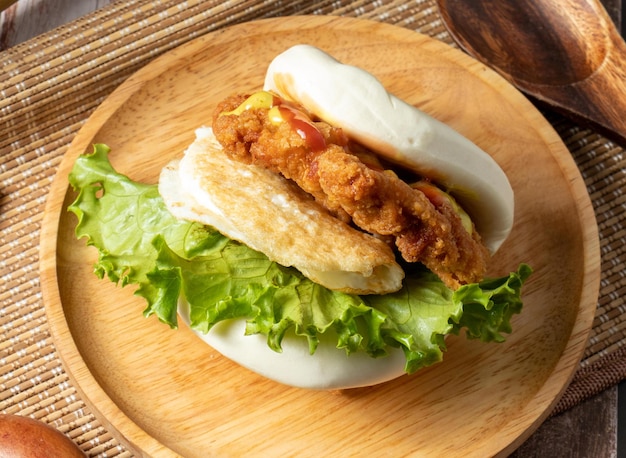 Tiger bites silver chicken sandwich served in wooden dish isolated on table side view of taiwan food