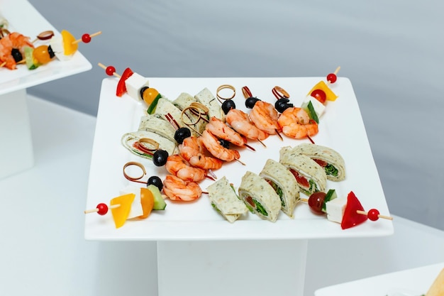 Tiger prawns on a skewer with olives Catering