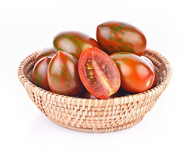 Tiger tomatoes in basket on white background