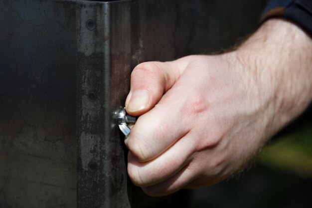 Tightening up a nut by hand Close up