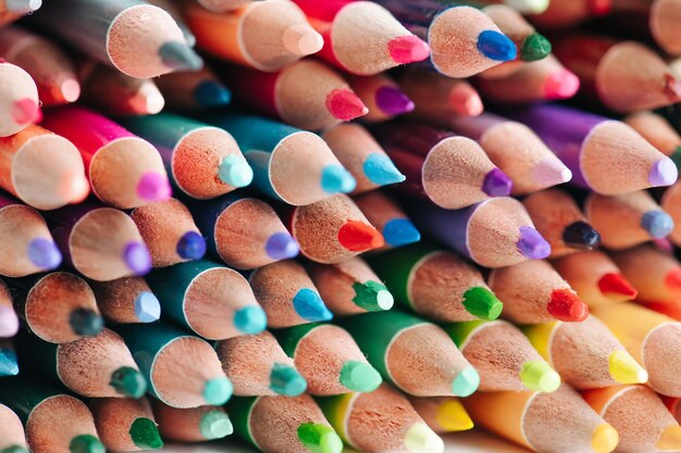 Tightly packed crayons in a stack Colored tips close up