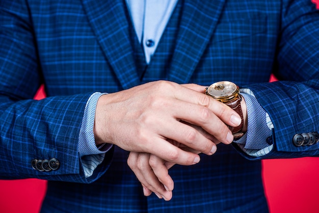 Tijd controleren op draagbaar uurwerk gedragen op mannenhand formele mode-stijl, horloge.