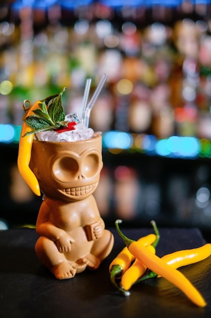 Tiki cocktail in a glass of natives garnished with pepper