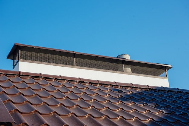 Tile Roof of a two-story white cottage