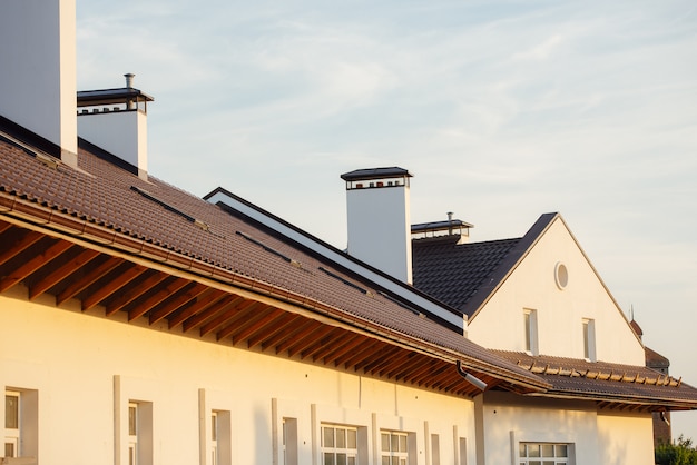 Tile Roof of a two-story white cottage