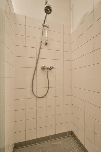 Tiled shower room lined with white tiles in brick style in a modern house