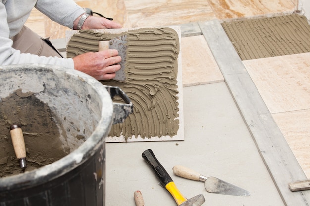 a tiler laying a tiled marble