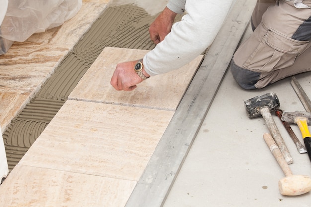 a tiler laying a tiled marble