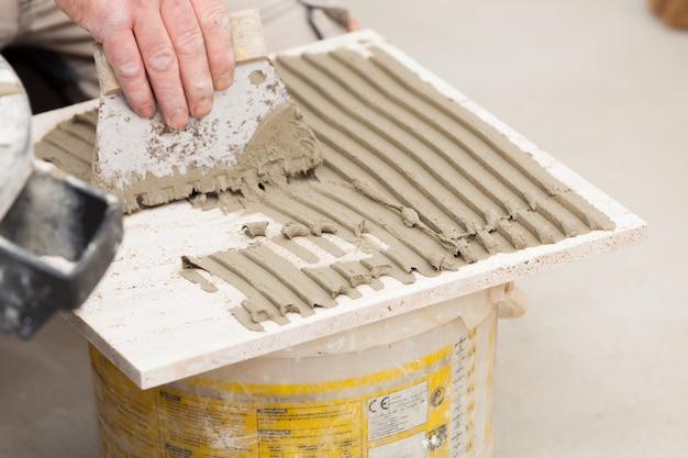 a tiler laying a tiled marble