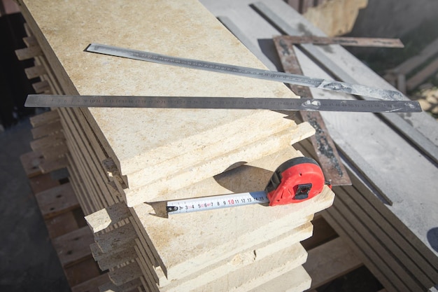 Tiles for house building with measuring tape