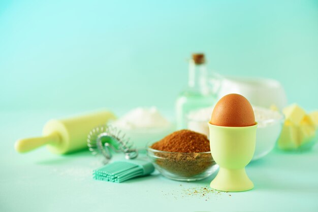 Time to bake baking ingredients butter sugar flour eggs oil spoon rolling pin brush whisk milk over blue background bakery food frame cooking concept copy space