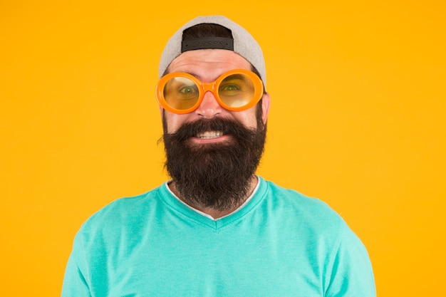 Time for fun. casual hipster outfit. funny man having fun. bearded guy in party glasses. just like a freak. he is going crazy. summer male fashion. happy and smiling hipster. Fun and entertainment.