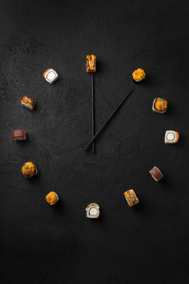 Time to have a snack with Japanese sushi rolls on a black background