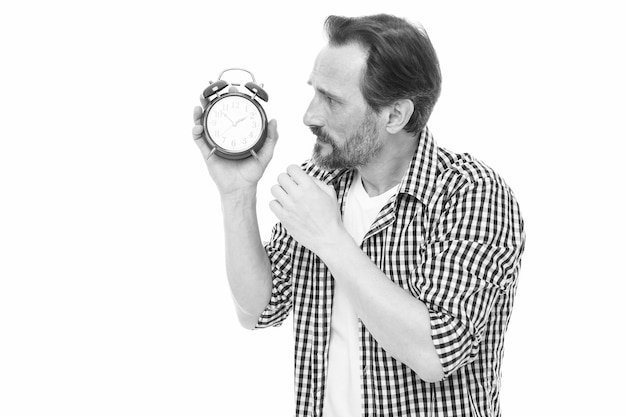 Time is marching on Senior man looking at clock Bearded man with clock Mature timekeeper with clock Mature man holding alarm clock Scheduling time Time management Time to rest