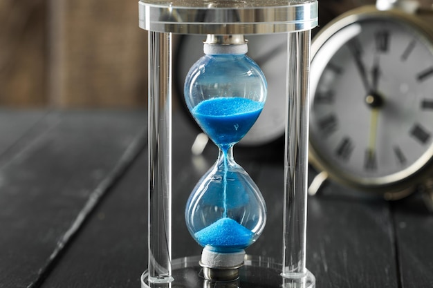 Time is passing blue hourglass close up