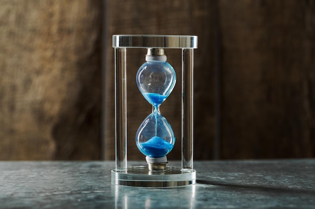 Time is passing blue hourglass close up