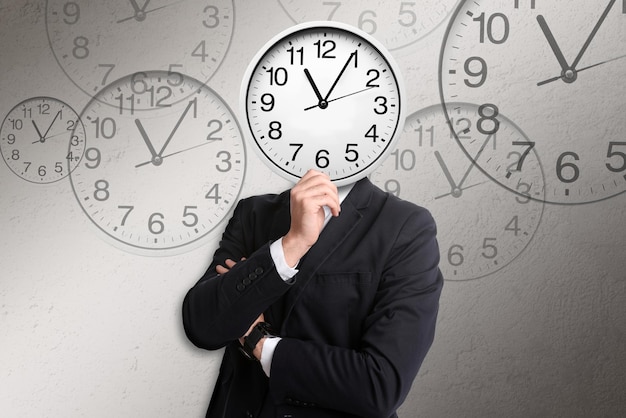 Time management concept Businessman with clock instead of head on light grey background