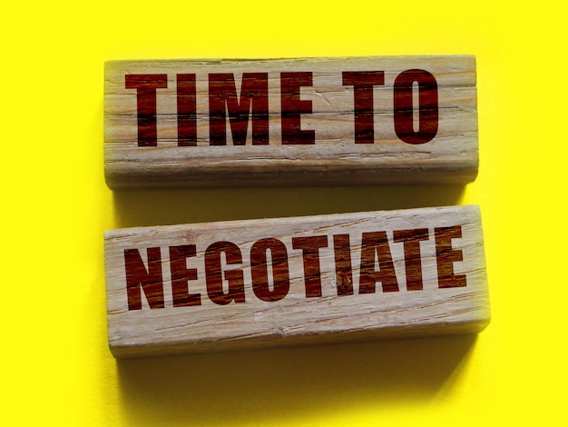 Photo time to negotiate text phrase on wooden blocks on vivid yellow background business contract agreement negotiations concept