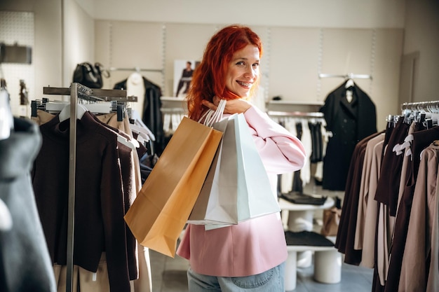 time for shopping with bags woman chooses clothes in retail store