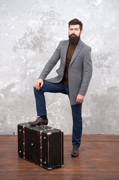 Time traveller concept. Vintage inspired design of bag. Retro and vintage. Fashion trend. Accessories for vacation. Best travel bags for men. Guy well groomed elegant bearded man and vintage suitcase.