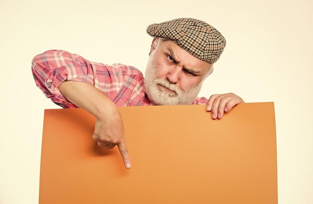 timing and schedule public information advertisement elderly people announcement concept pensioner hold poster information copy space senior bearded man peeking out of banner place information