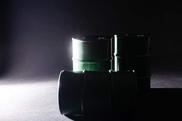 Tin barrels on black background isolated close up, one round\
oil drum, steel keg, tin food can, canister, aluminium cask,\
petroleum storage packaging, fuel container, gasoline tank, canned\
goods