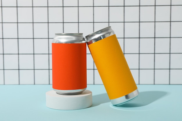 Photo tin cans on blue table on light background