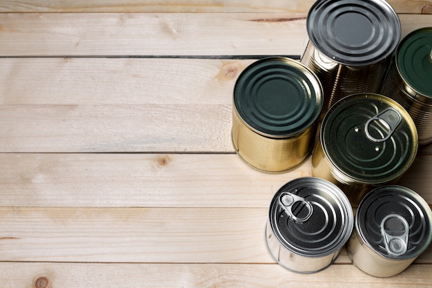 Tin cans for food on wooden 