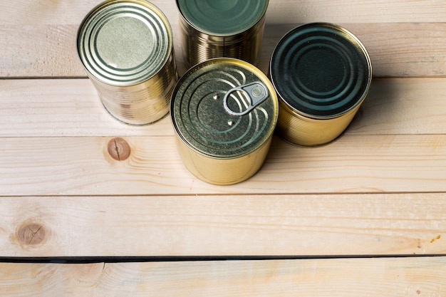 Tin cans for food on wooden 