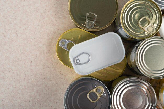 Photo tin cans on kitchen table background with copy space flat lay