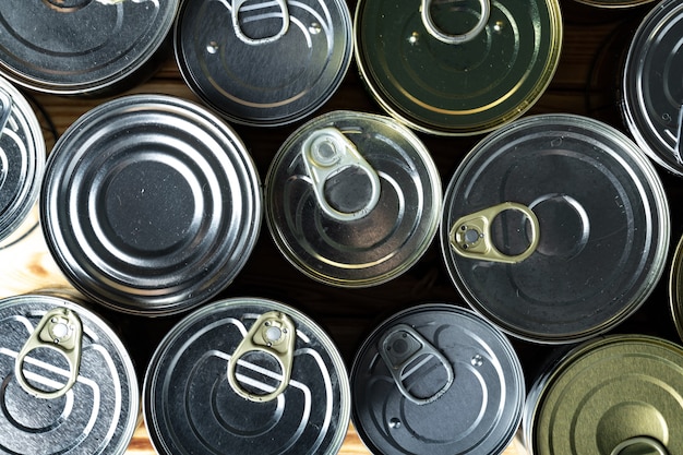 Tin cans with food on the table. Close up.