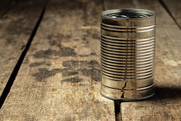 Tin cans with food on the table.