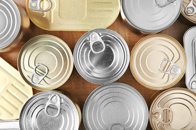 Tin cans on wooden background closeup