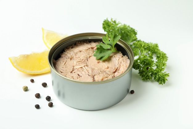 Tin with canned tuna on white background