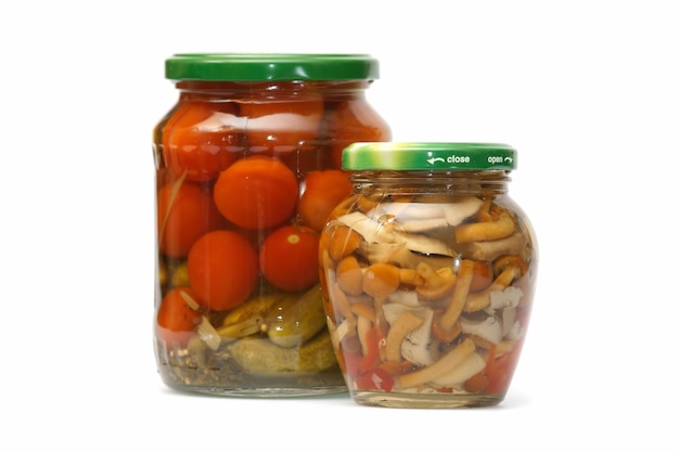 Tinned tomatoes and cucumbers in glass bank