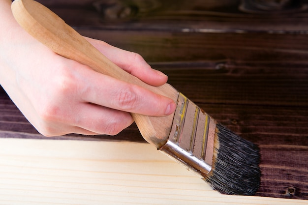 Photo tinting in the dark color of wood with a brush.