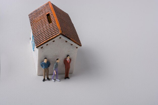 Tiny figurine of men in front of a house