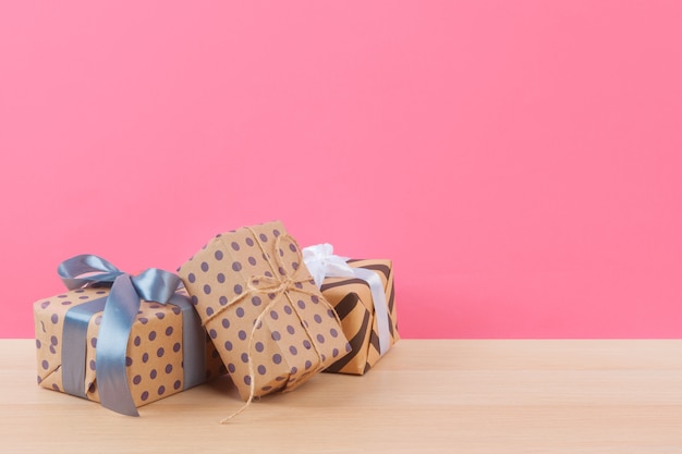 Tiny gift box on pastel pink background