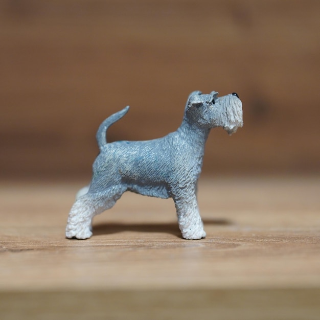 A tiny gray dog sitting on top of a wooden table