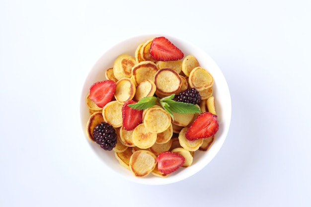 Tiny pancakes for breakfast with strawberry, blackberry and mint