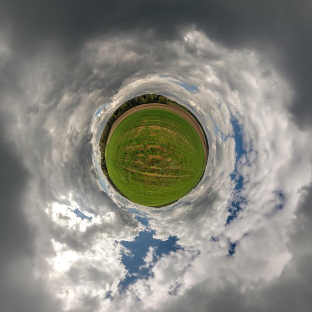 Tiny planet in blue sky with beautiful clouds with\
transformation of spherical panorama 360 degrees spherical abstract\
aerial view curvature of space