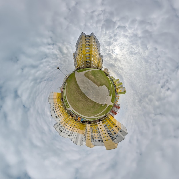 Tiny planet in blue sky with clouds in city center near modern skyscrapers Transformation of spherical 360 panorama in abstract aerial view