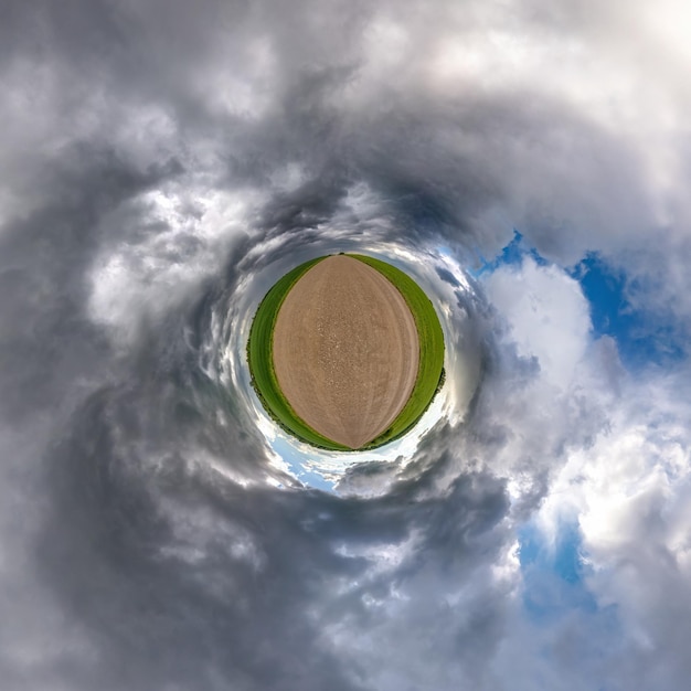 Tiny planet in blue sky with sun and beautiful clouds\
transformation of spherical panorama 360 degrees spherical abstract\
aerial view curvature of space